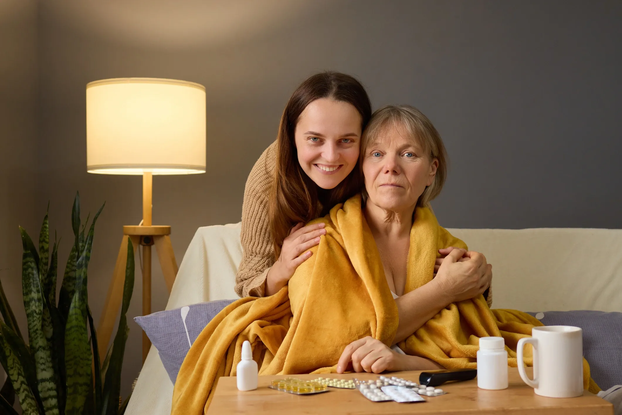 Caregiver providing compassionate assistance to an elderly person at home